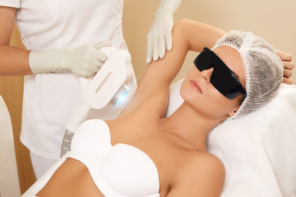 Doctor treating lady's underarms | Get Laser hair removal treatment in A Nu U Aesthetics at Congers, New York